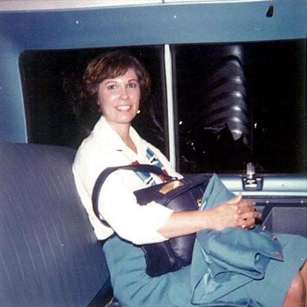 1970s A Pan Am flight attendant waits patiently in the crew van for a soon to come hotel rest 
